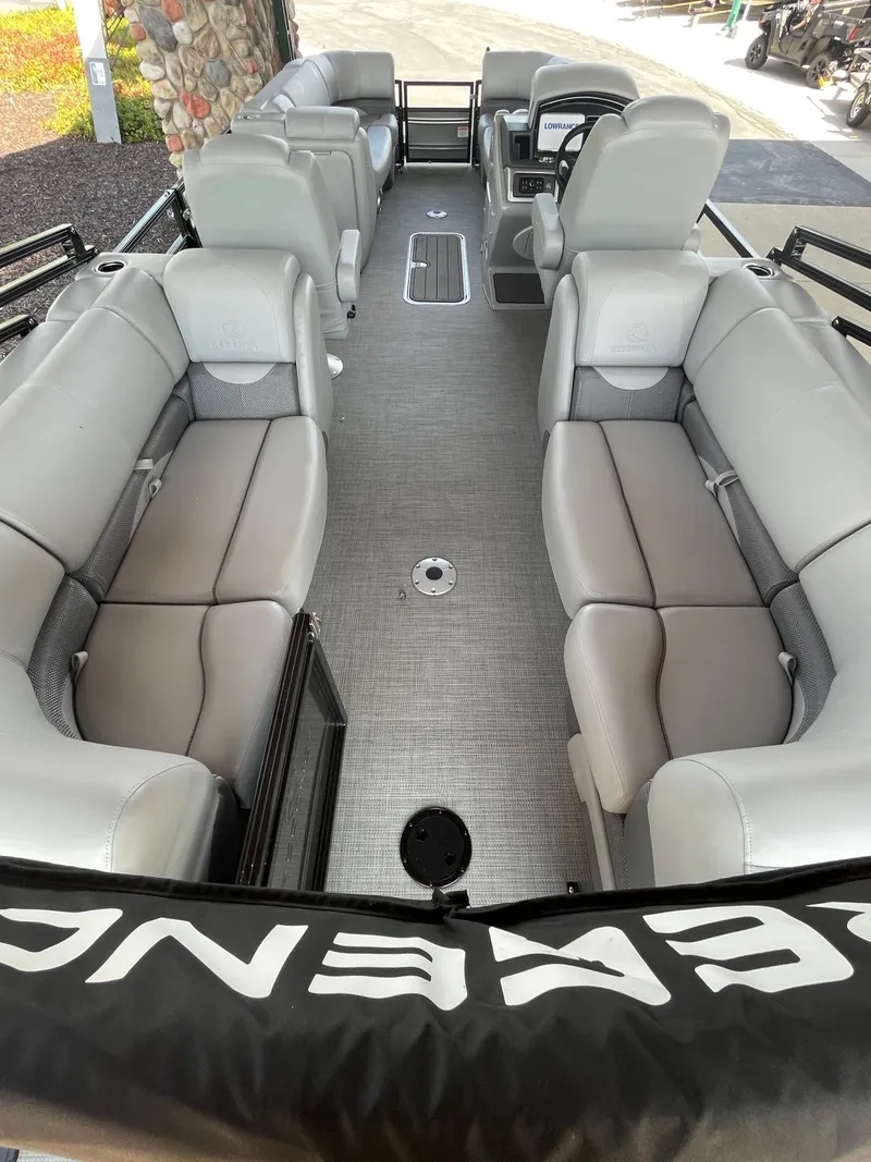 Slide: The Image of 2024 Regency 230 DL3 pontoon boat interior with plush seating and modern design. - 4