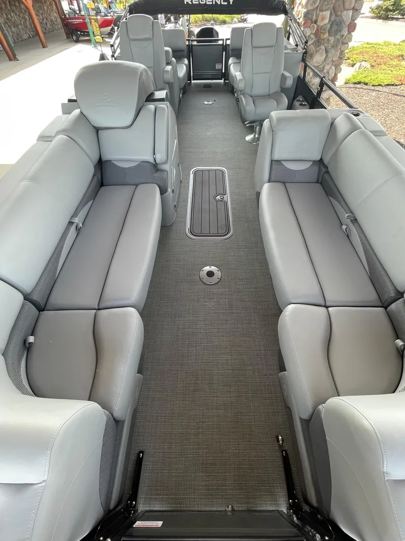 Slide: The Image of 2024 Regency 230 DL3 pontoon boat interior with spacious gray seating and modern design. - 5