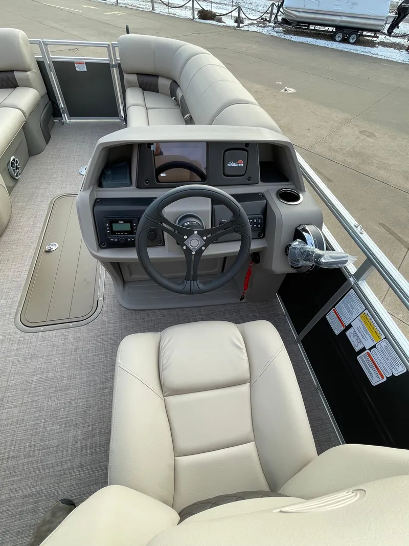 Slide: The Image of 2024 Sun Tracker Party Barge 22 XP3 interior, featuring helm and seating area. - 4