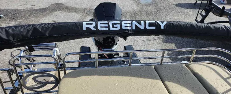 Slide: The Image of 2024 Regency 250 LE3 Sport boat rear view with engine and railing. - 10