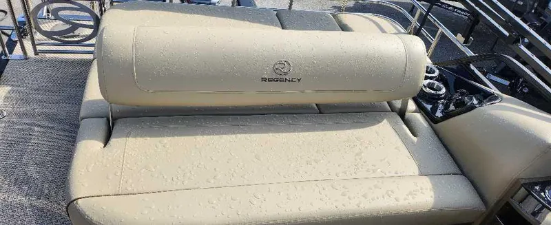 Slide: The Image of 2024 Regency 250 LE3 Sport boat with beige seating and logo. - 11
