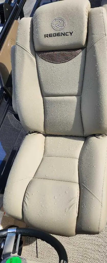 Slide: The Image of 2024 Regency 250 LE3 Sport boat seat with beige upholstery. - 13