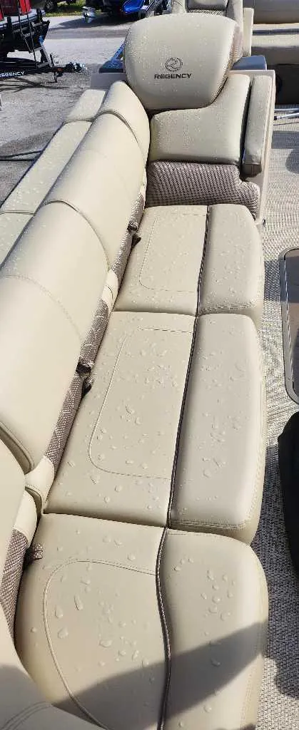 Slide: The Image of 2024 Regency 250 LE3 Sport boat with beige leather seating. - 14