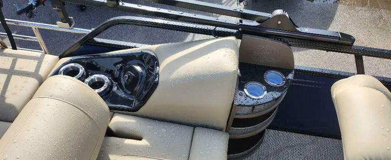 Slide: The Image of 2024 Regency 250 LE3 Sport boat interior with beige seating and cup holders. - 5