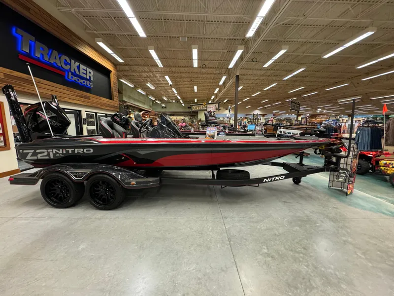Slide: The Image of 2024 Nitro Z21 XL boat displayed indoors at Tracker Boats showroom. - 2