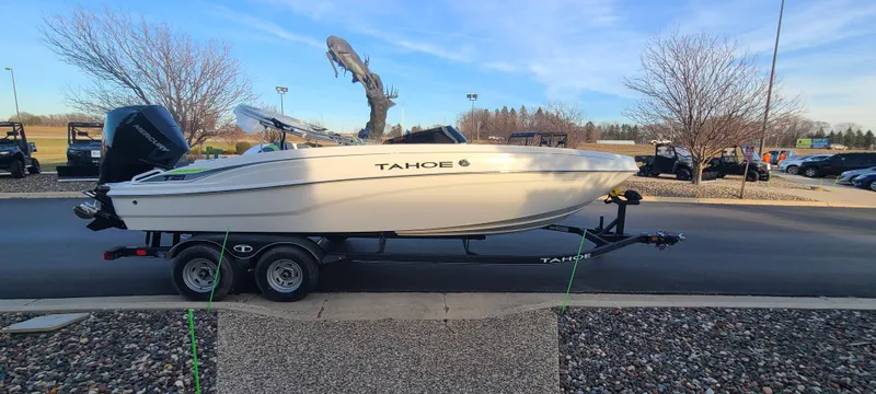 Slide: The Image of 2024 Tahoe T21 boat on a trailer, parked outdoors. - 3