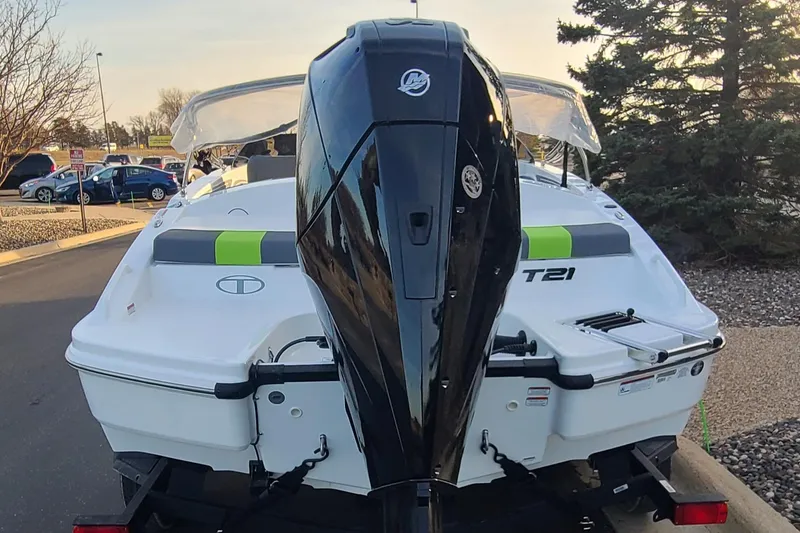 Slide: The Image of 2024 Tahoe T21 boat with powerful outboard motor, parked outdoors. - 4