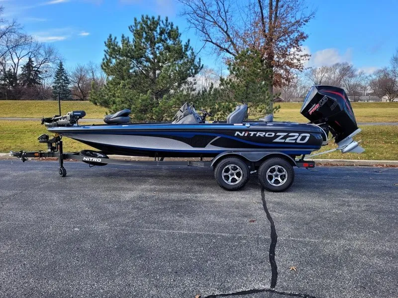 Slide: The Image of 2024 Nitro Z20 Pro fishing boat on trailer in outdoor setting. - 0