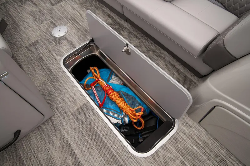Slide: The Image of 2024 Ranger Reata 223C under-seat storage compartment with boating accessories. - 38