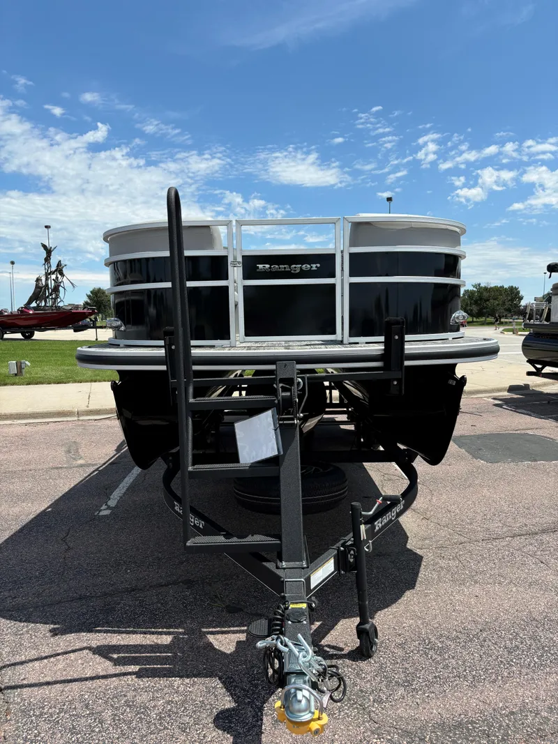 Slide: The Image of 2024 Ranger Reata 223C pontoon boat on a trailer under a clear sky. - 4