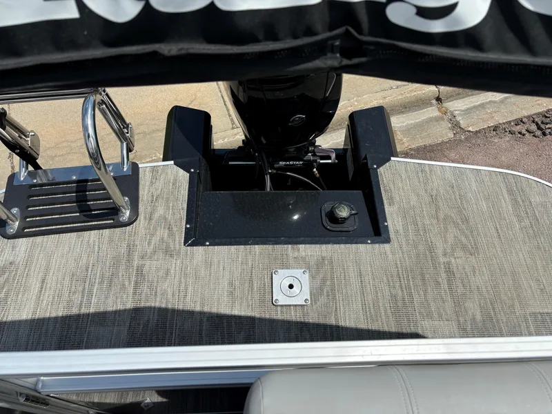 Slide: The Image of 2024 Ranger Reata 223C boat stern with motor and swim ladder. - 5