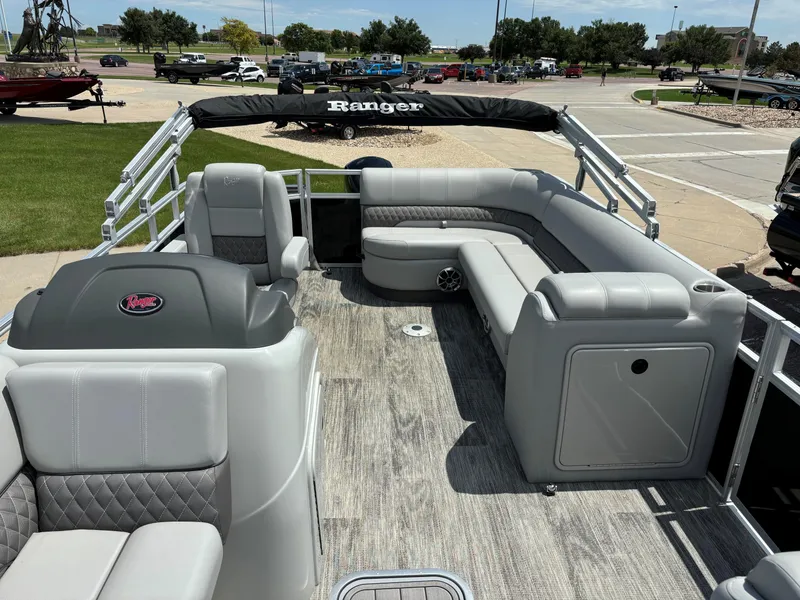 Slide: The Image of 2024 Ranger Reata 223C pontoon boat with spacious seating and modern design. - 6