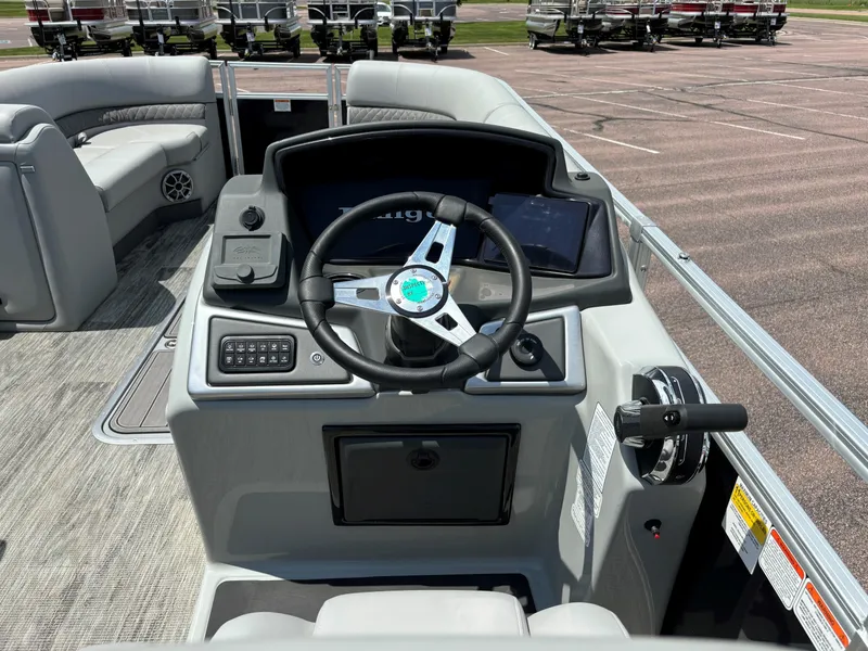 Slide: The Image of 2024 Ranger Reata 223C boat cockpit with steering wheel and control panel. - 8