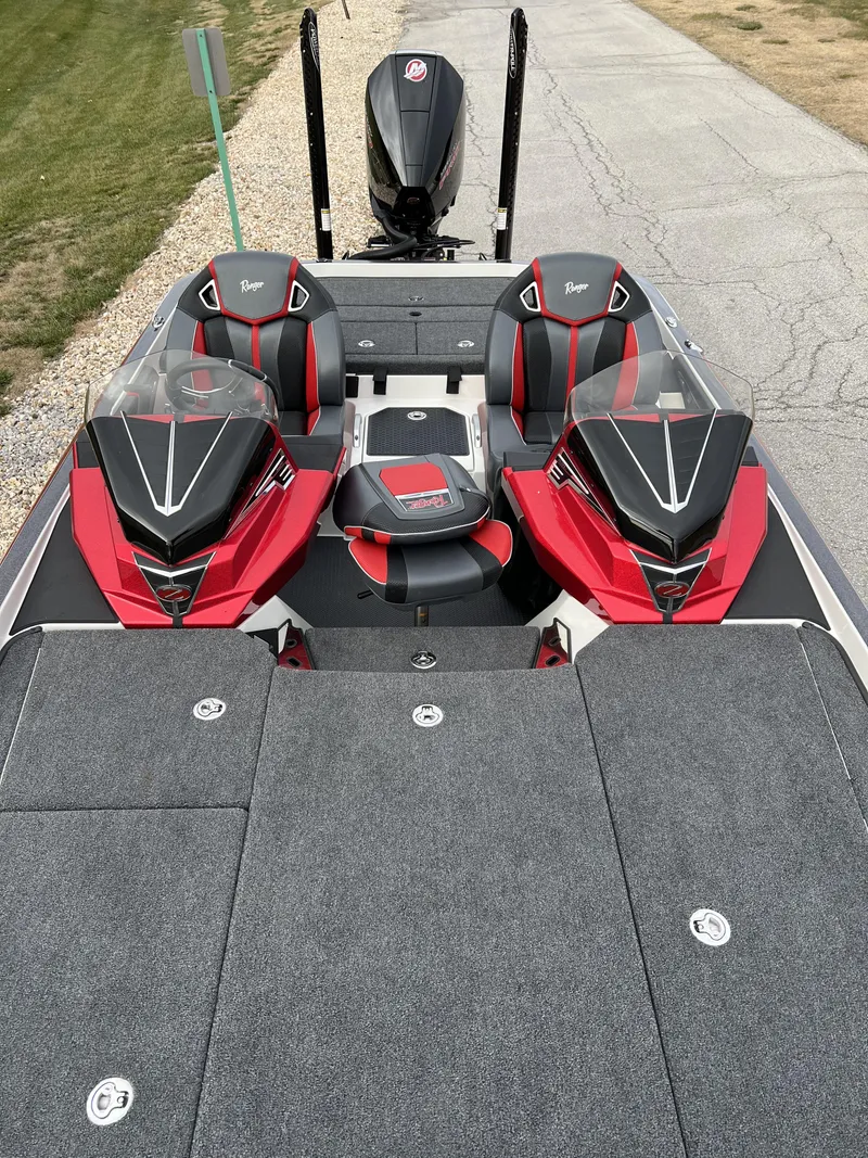 Slide: The Image of 2024 Ranger Z521R fishing boat with red and black seats and dual consoles. - 11