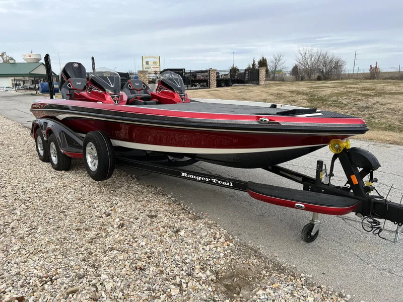 Slide: The Image of 2024 Ranger Z521R bass boat on trailer, red and black, parked outdoors. - 3