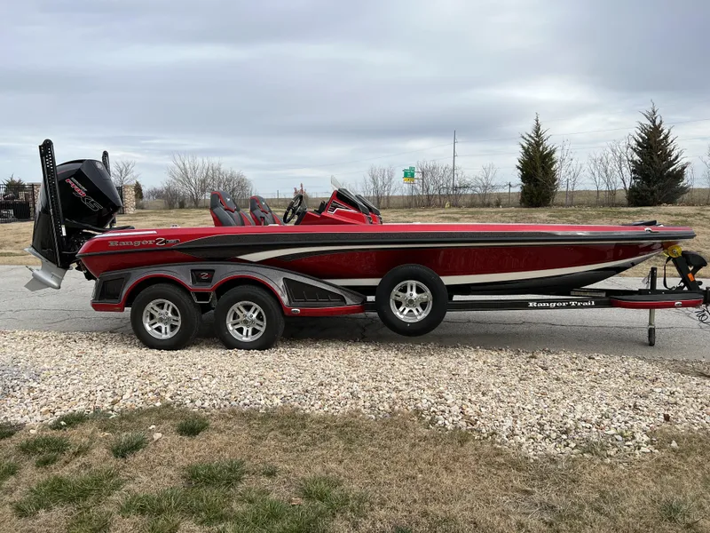 Slide: The Image of 2024 Ranger Z521R boat on a trailer, red and black color scheme. - 4