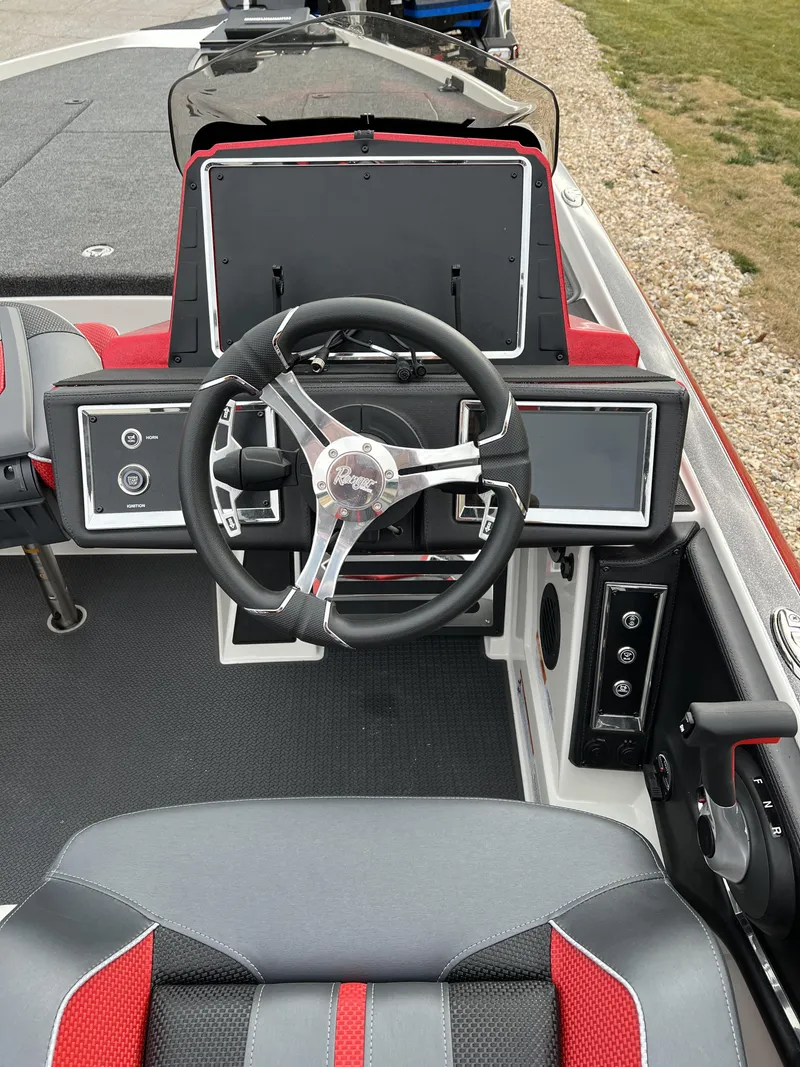 Slide: The Image of 2024 Ranger Z521R boat dashboard with steering wheel and control panels. - 8