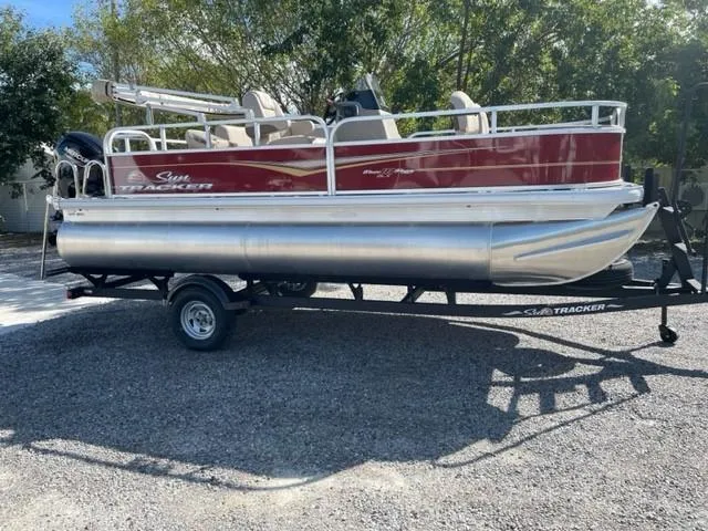 Slide: The Image of 2024 Sun Tracker Bass Buggy 18 DLX pontoon boat on a trailer. - 5