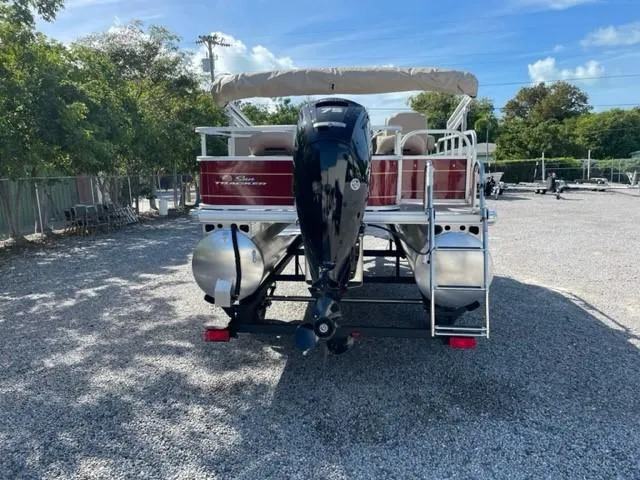 Slide: The Image of 2024 Sun Tracker Bass Buggy 18 DLX pontoon boat, rear view with outboard motor. - 9