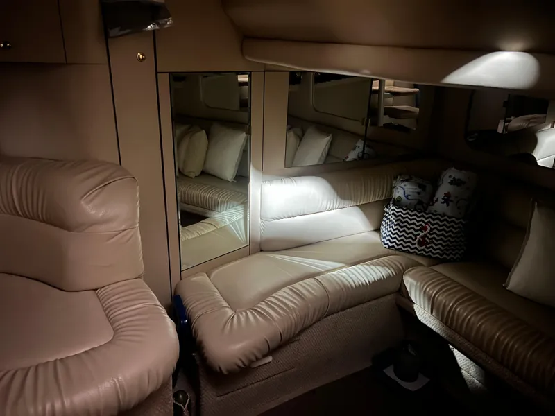 Slide: The Image of Luxurious interior of 1999 Sea Ray 380 Sundancer yacht with leather seating and mirrors. - 14