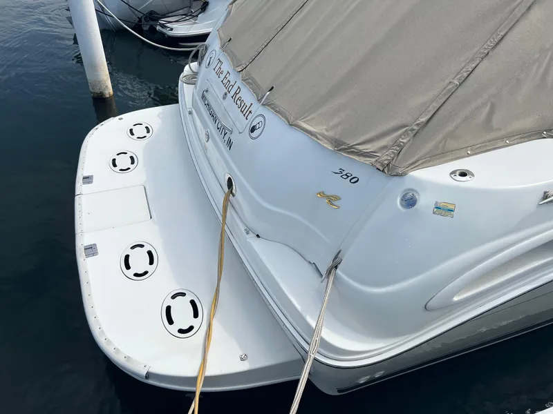 Slide: The Image of 1999 Sea Ray 380 Sundancer docked, rear view with cover. - 3
