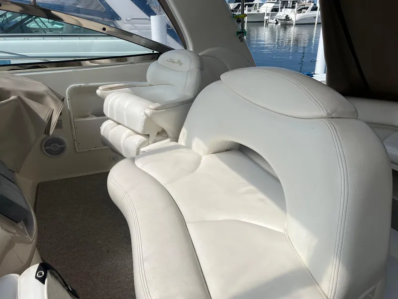 Slide: The Image of 1999 Sea Ray 380 Sundancer interior with white leather seating at marina. - 4