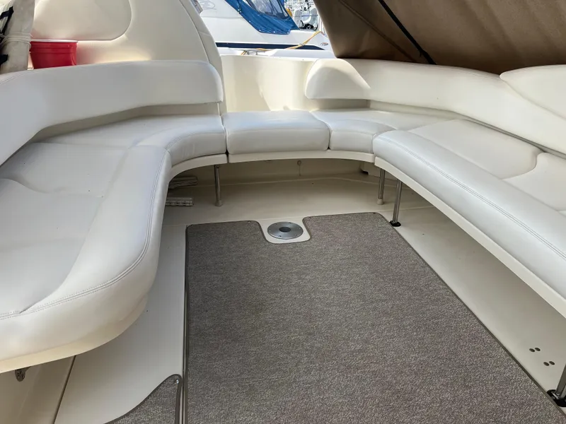 Slide: The Image of 1999 Sea Ray 380 Sundancer interior with white leather seating and carpeted floor. - 5