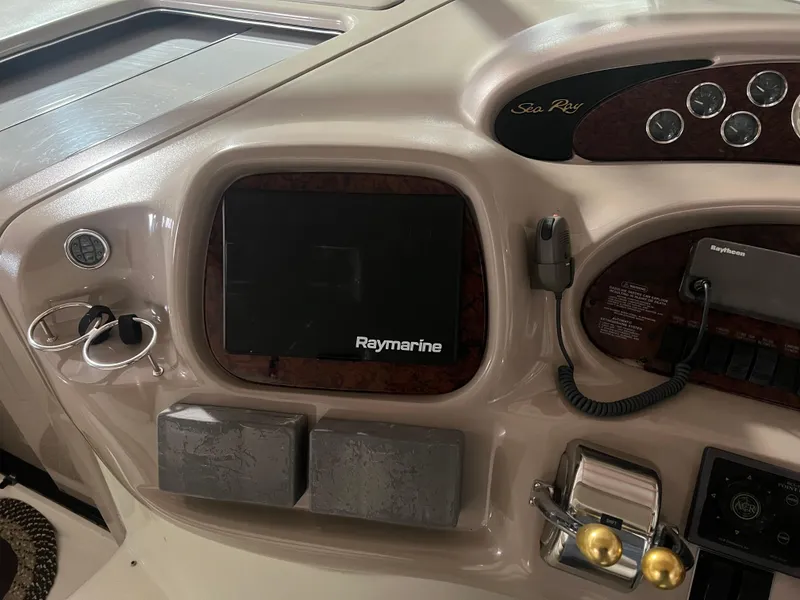 Slide: The Image of 1999 Sea Ray 380 Sundancer dashboard with Raymarine navigation system. - 6
