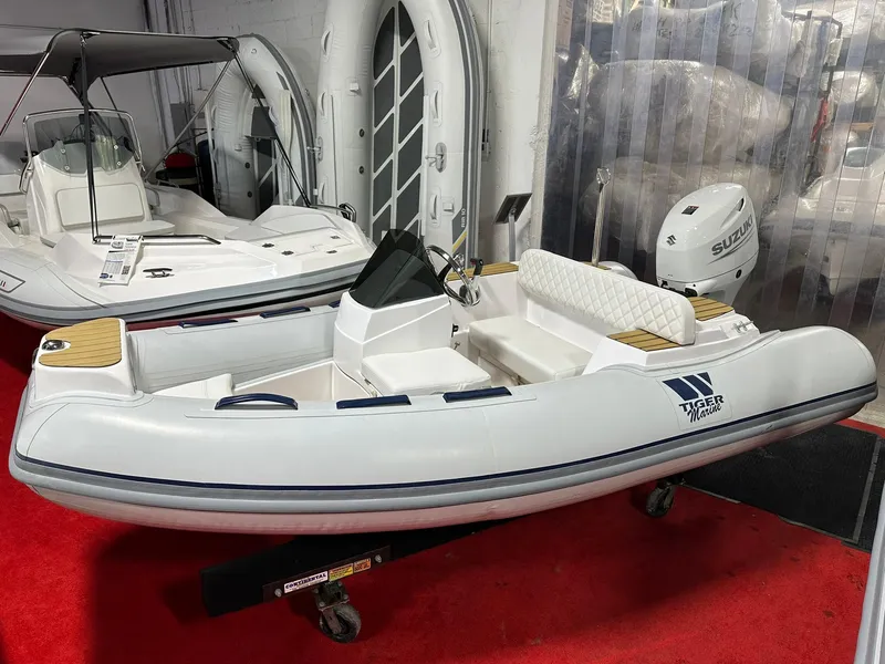 The Image of 2024 Tiger Marine PT 340 inflatable boat on display with red carpet background. - 1