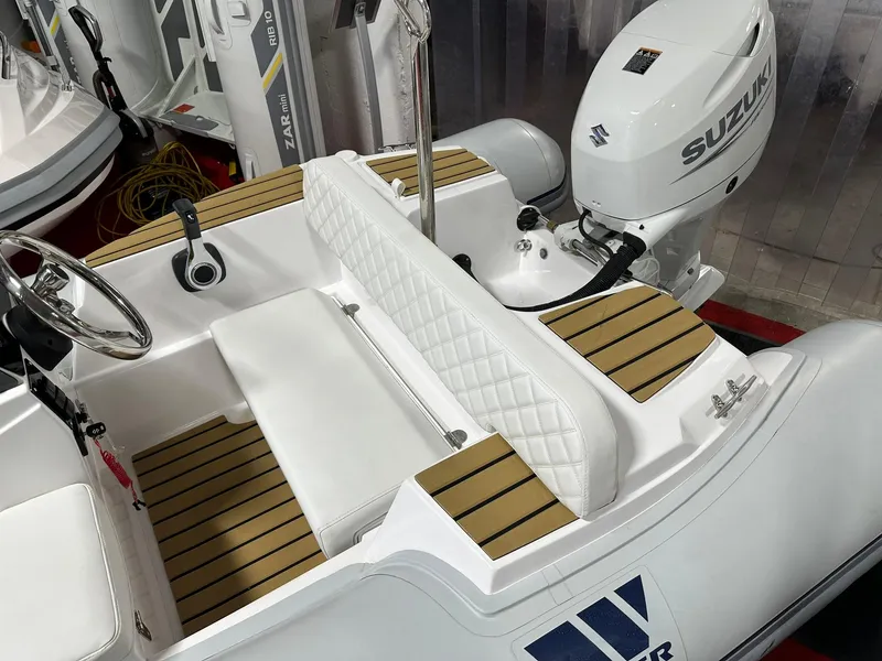 Slide: The Image of 2024 Tiger Marine PT 340 boat interior with Suzuki outboard motor. - 2