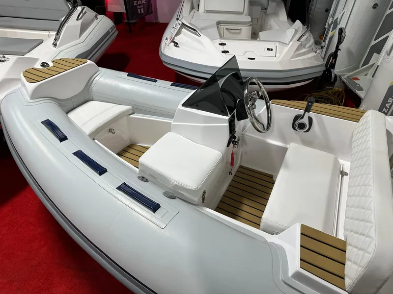 Slide: The Image of 2024 Tiger Marine PT 340 inflatable boat with white seating and wooden accents. - 3