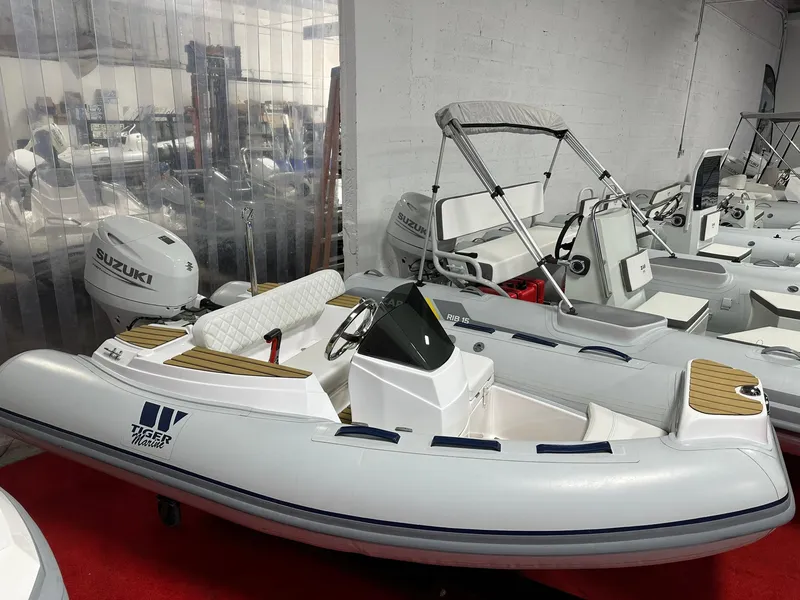 Slide: The Image of 2024 Tiger Marine PT 340 inflatable boat with Suzuki outboard motor in showroom. - 5