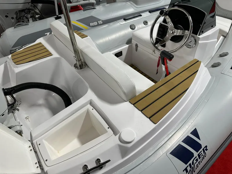 Slide: The Image of 2024 Tiger Marine PT 340 boat interior with steering wheel and seating. - 6
