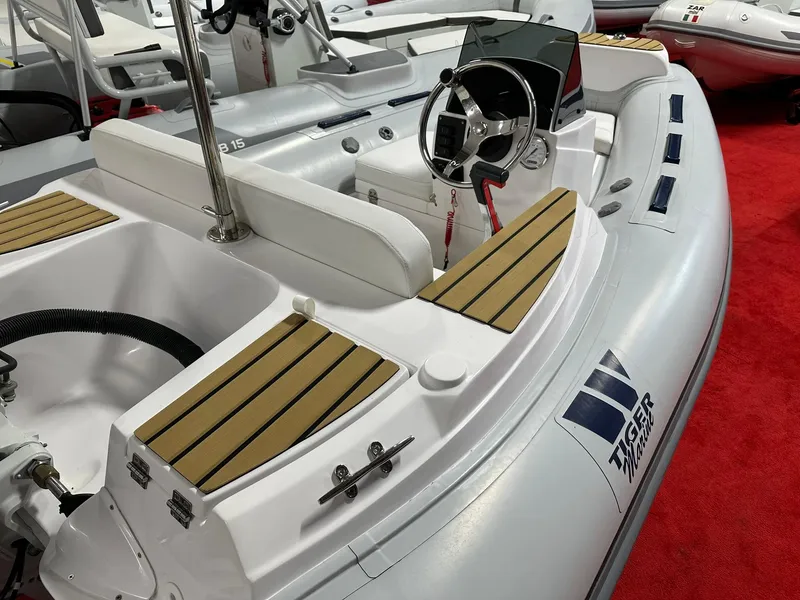 Slide: The Image of 2024 Tiger Marine PT 340 inflatable boat with steering console and seating on display. - 7