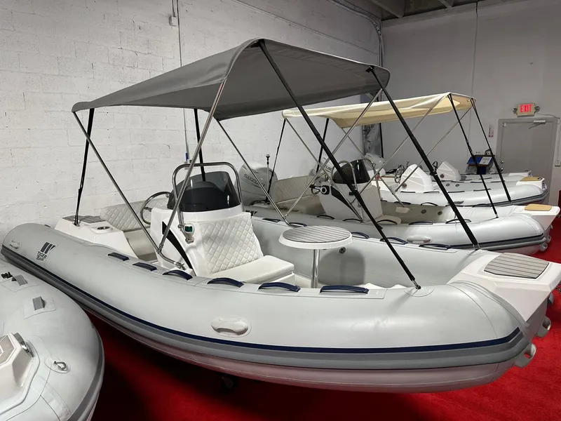 Slide: The Image of 2024 Tiger Marine SL 480 inflatable boat with canopy in showroom. - 1