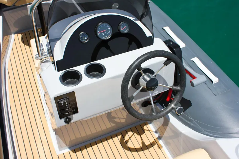 Slide: The Image of 2024 Tiger Marine SL 480 boat dashboard with steering wheel and gauges. - 11