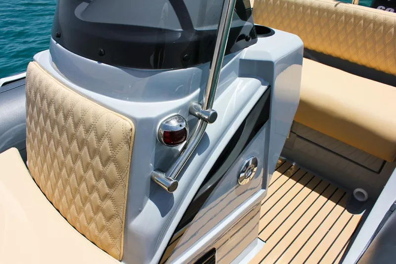 Slide: The Image of 2024 Tiger Marine SL 480 boat interior with beige diamond-stitched upholstery and sleek design. - 13