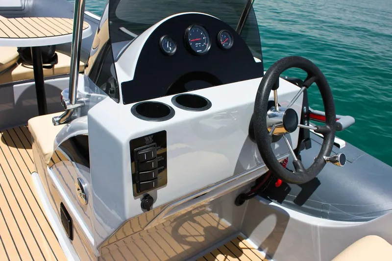 Slide: The Image of 2024 Tiger Marine SL 480 boat dashboard with steering wheel and control panel. - 14