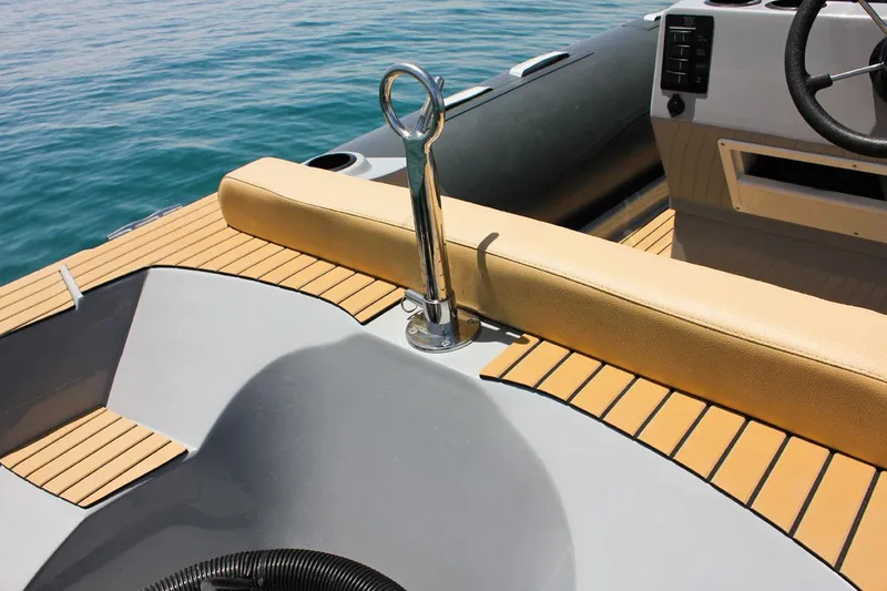Slide: The Image of 2024 Tiger Marine SL 480 boat interior with tan seating and wood accents. - 16