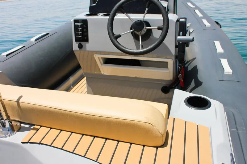 Slide: The Image of Tiger Marine SL 480 2024 model boat interior with steering wheel and beige seating. - 18