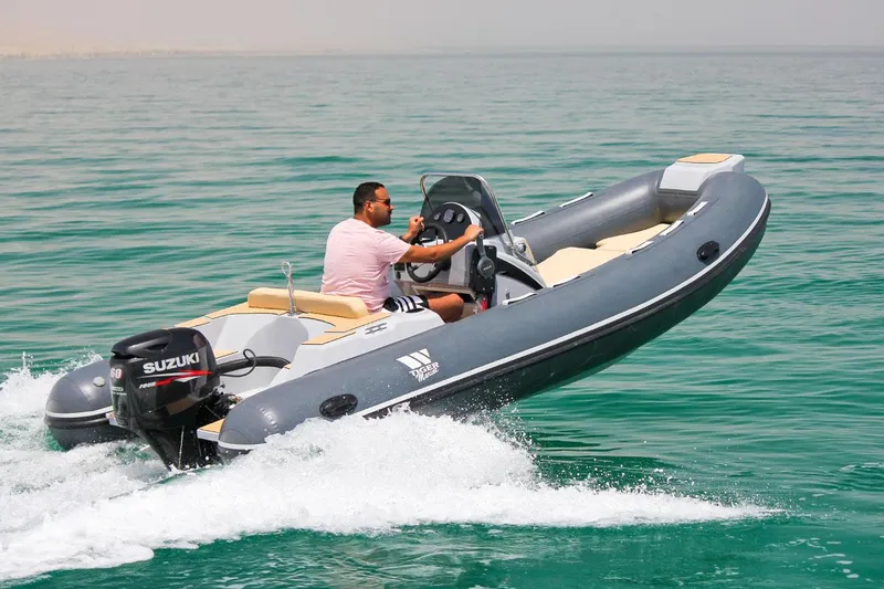 Slide: The Image of 2024 Tiger Marine SL 480 boat cruising on clear water. - 24