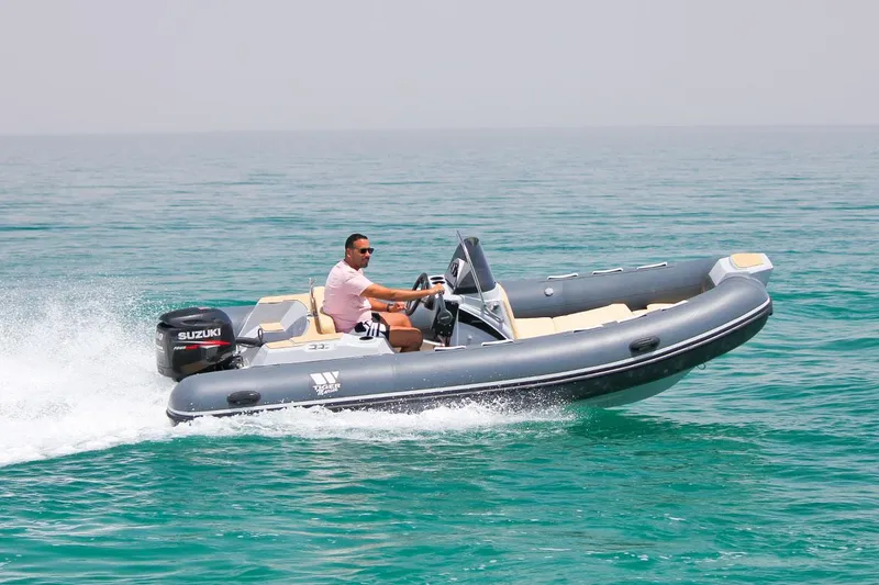 Slide: The Image of 2024 Tiger Marine SL 480 boat cruising on the water with a Suzuki outboard motor. - 25