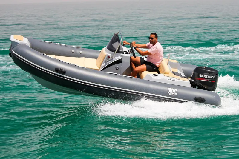Slide: The Image of 2024 Tiger Marine SL 480 boat cruising on clear blue water. - 26
