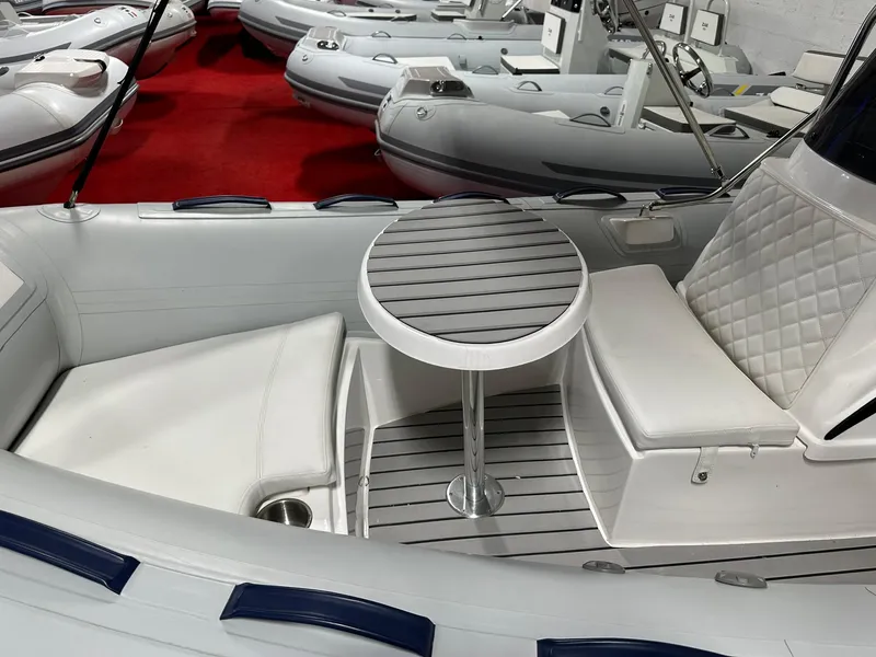 Slide: The Image of 2024 Tiger Marine SL 480 boat interior with seating and table. - 3