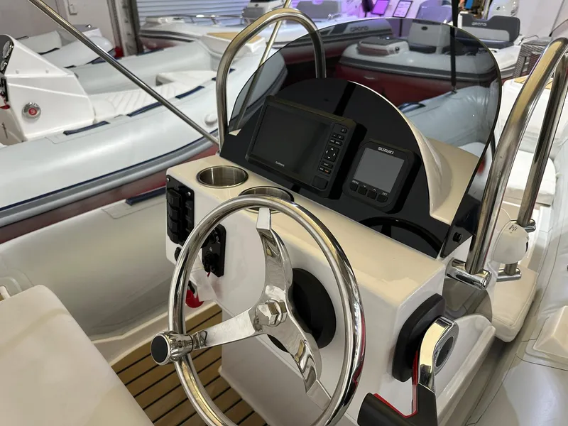 Slide: The Image of 2024 Tiger Marine SL 480 boat dashboard with steering wheel and navigation equipment. - 4