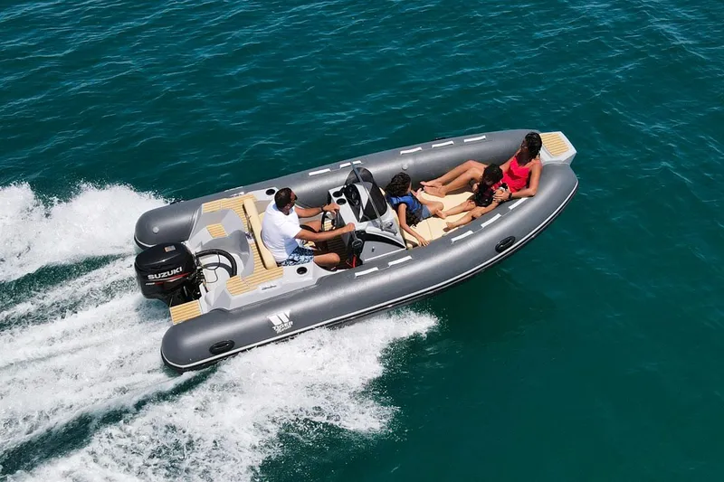 Slide: The Image of 2024 Tiger Marine SL 480 boat cruising with passengers on blue water. - 6