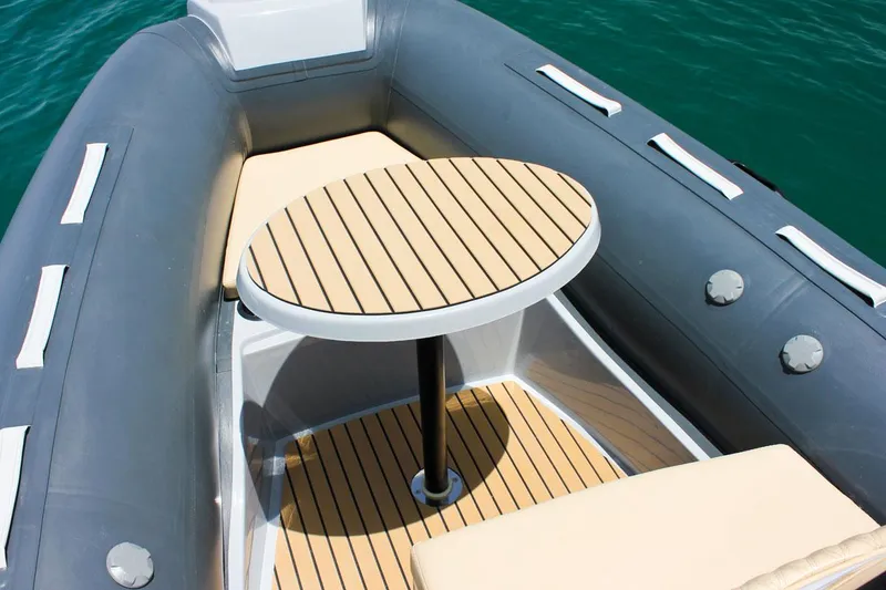 Slide: The Image of Tiger Marine SL 480 2024 boat interior with wooden table and cushioned seating. - 7