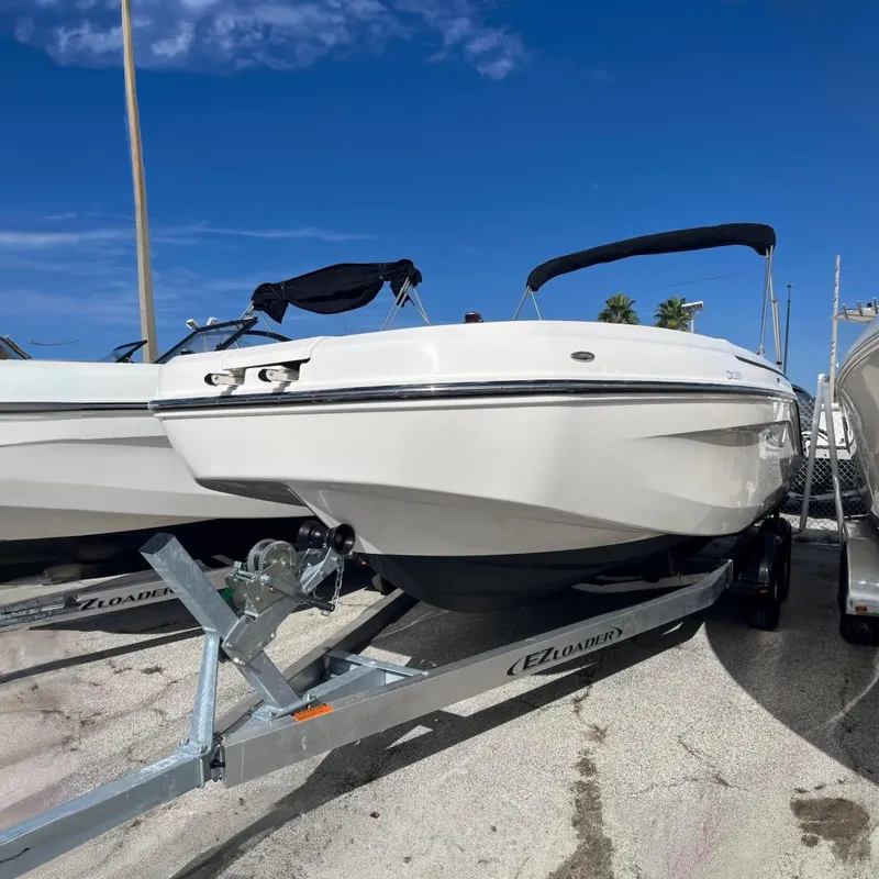 The Image of 2021 Bayliner DX 2200 boat on EZ Loader trailer, parked outdoors. - 0
