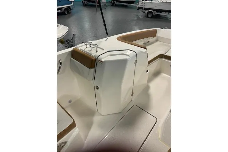 Slide: The Image of 2021 Bayliner DX 2200 boat interior with seating and storage compartment. - 12