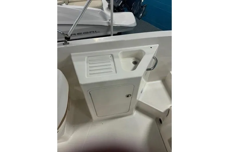 Slide: The Image of Bayliner DX 2200 boat interior with sink and storage, 2021 model. - 13